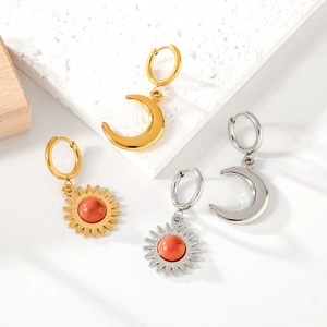Detail of sun and moon stainless steel earrings in gold and silver finish with orange beads