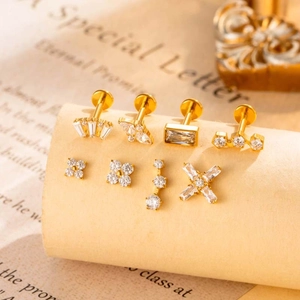 Set of 8 gold titanium labret studs with cubic zirconia crystals on vintage paper