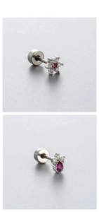 Detail of surgical steel stud earrings featuring pink zircon flower and magenta gemstone