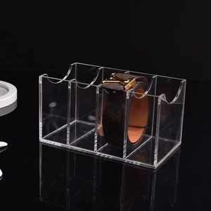 Transparent acrylic belt organizer with 4 slots and U-shaped openings on black background