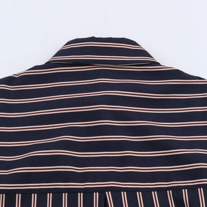 Detail of navy blue shirt featuring red and white fine stripes and neck stitching
