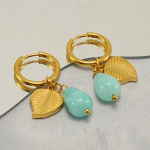 Golden titanium steel hoop earrings featuring leaf pendants and blue turquoise beads