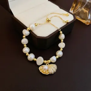 Baroque freshwater pearl bracelet with shell tassel and adjustable gold chain