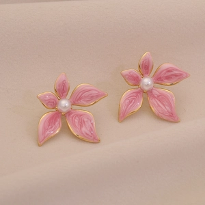 Close-up of pink marble pattern flower earrings with white pearl and gold edges