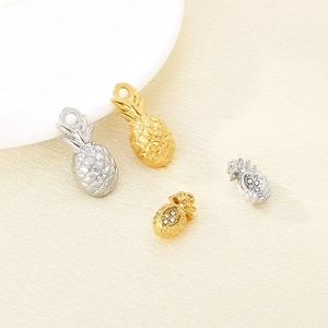 Hollow pineapple pendants in gold and silver steel with clear crystal accents