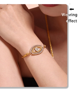 Close-up of golden Evil Eye bracelet with zircon stones and adjustable chain on wrist