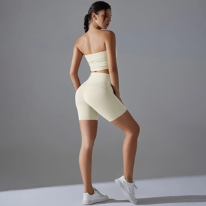 Detail view of high-waist cream yoga shorts showing the butt-lifting and slimming effect
