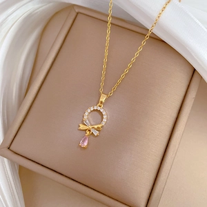 Close-up of titanium steel necklace with sparkling crystal ring and pink teardrop gem