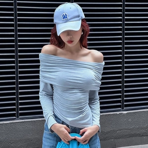 Close-up of the light blue ruched off-shoulder top with irregular hem and soft fabric texture