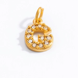Macro shot of 18K gold plated letter G pendant with sparkling cubic zirconia stones