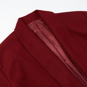 Detailed close-up of wine red wool coat collar with premium satin lining texture