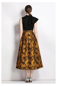 Back view of a refined jacquard dress featuring golden floral patterns and ruffled collar