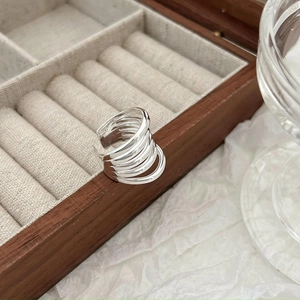 Elegant multi-layer S925 sterling silver winding ring displayed on a luxury jewelry box
