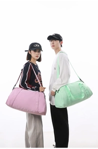 Models displaying large pink and mint green travel duffle bags in a clean studio setting