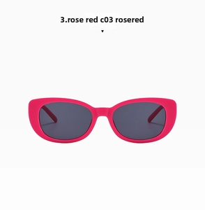 Detail view of stylish rose red cat eye sunglasses with dark grey UV protective lenses