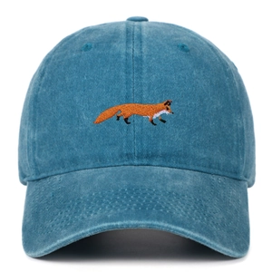 Close-up of vibrant fox embroidery on a vintage washed navy blue cotton baseball cap