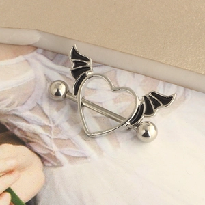 Silver heart nipple shield with black bat wings on a minimalist background