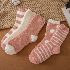 Thick pink and white coral fleece winter socks with striped and polka dot patterns