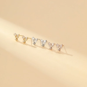 Detailed view of three pairs of S925 silver bow earrings with sparkling zircon stones