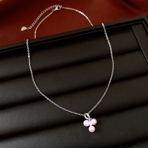 Detail of pink pearl clover pendant with zircon on elegant silver chain necklace