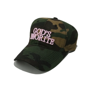 Macro shot of 3D pink 'GOD'S FAVORITE' embroidery on a camouflage baseball cap fabric