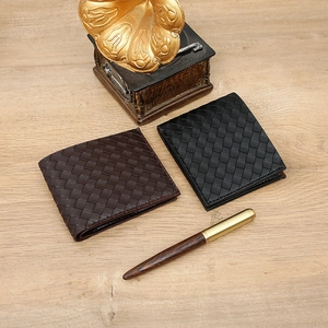 Detailed view of woven leather texture on short bi-fold men's wallets in black and brown
