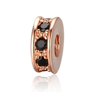 Macro shot of rose gold copper rondelle spacers with inlaid black cubic zirconia stones
