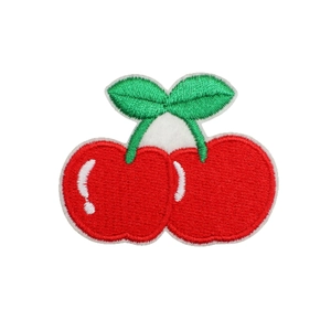 Cute cherry embroidered patch with red fruits and green leaves on white background