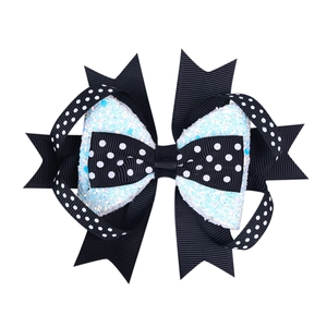 Detail of multi-layered bow hair clip with black polka dots and white glitter fabric
