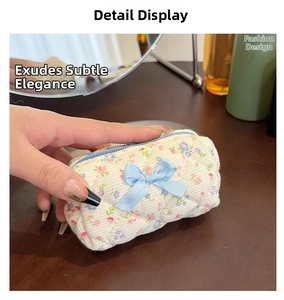 Close-up of quilted floral cotton makeup bag with bow and zipper detail