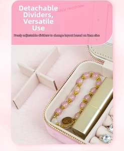 Pink velvet jewelry box detail showing adjustable dividers for rings and earrings