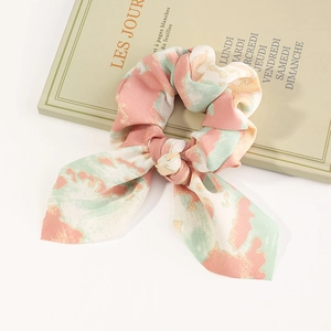 Chic tie-dye bow scrunchie with colorful ribbons in pink and green silk texture