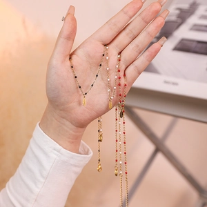 Minimalist stainless steel necklaces with gold feather pendants and colorful seed beads