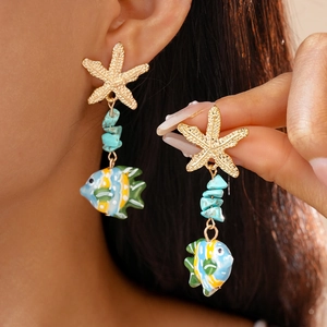 Detailed view of beach style starfish earrings with turquoise beads and tropical fish charms