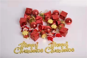 Detailed assortment of red Christmas tree ornaments, bells, and golden Merry Christmas sign