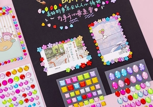 Close-up of colorful 3D acrylic rhinestone stickers decorating a photo frame and album
