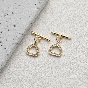 Detailed macro view of 14K gold plated heart OT toggles with micro-set zircon accents