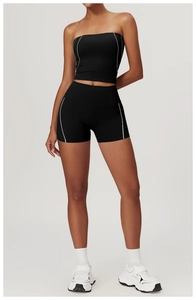 Close-up of black yoga set featuring white side stripes on the sports bra and high-waist shorts