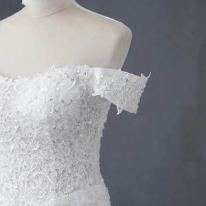 Elegant off-shoulder mermaid wedding dress with detailed white lace and sequins