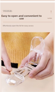 Macro view of portable pill cutter showing transparent structure and metal cutting blade
