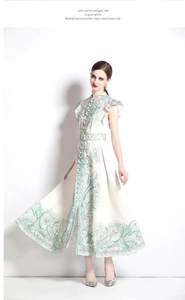Detail of vintage paisley print dress with stand collar, buttons and ruffled shoulders