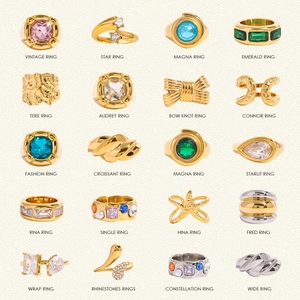 Collection of minimalist stainless steel rings with zircon and pearls on beige texture