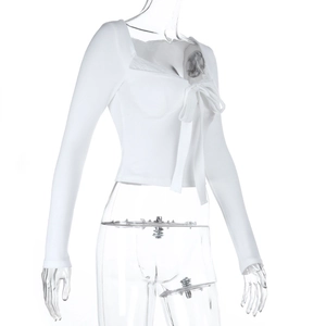 Close-up of white lace trim collar and bow tie detail on a long sleeve crop top