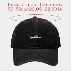 Close-up of black denim baseball cap with white Asher cursive embroidery and size info