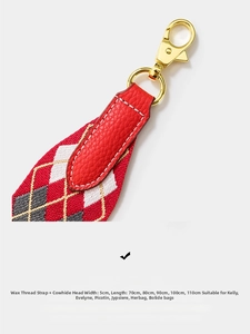 Macro shot of 5cm wide red diamond weave bag strap with cowhide ends and gold hardware