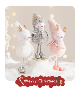Close-up of plush Christmas snowmen and reindeer dolls with long legs on snow background