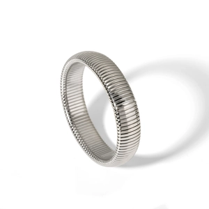 Macro view of silver stainless steel cuff with industrial horizontal ribbed textures