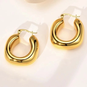Polished 18k gold plated stainless steel crescent hoop earrings with a chunky C-shaped design