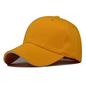 Detail of yellow sandwich baseball cap showing side profile and white brim layering