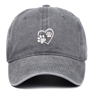 Detailed view of white heart and paw embroidery on a washed dark gray cotton baseball cap